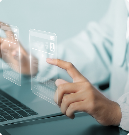 A healthcare professional interacting with digital patient information on a laptop.