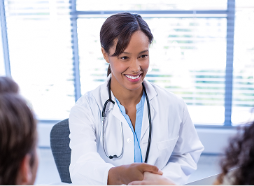 Patient interacting with a health professional at a self-service kiosk.
